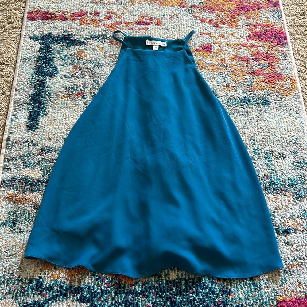 High neck teal tank with a ruffle split back purchased from a boutique